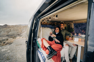 Couple enjoying camper van life in scenic desert landscape