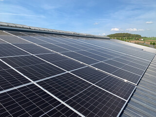 Extensive Solar Panel Array on the Metal Roof of a Large Industrial Facility