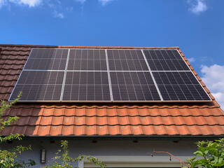 Red Tiled Roof of a Residential House with Installed Solar Panels