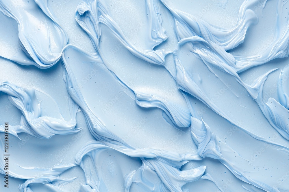 Poster close-up of smooth, swirling blue cream creating an abstract pattern. the textured surface showcases