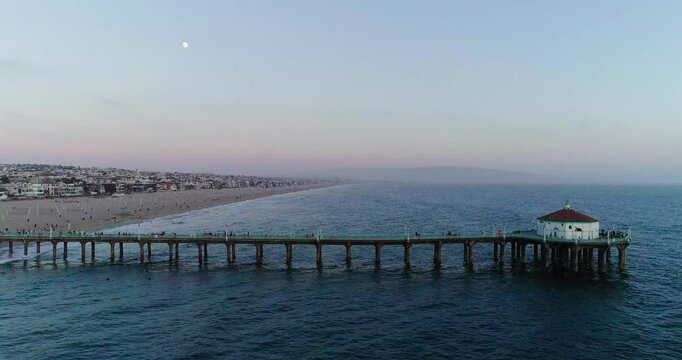 Beautiful beach sunset aerial view drone along pier 