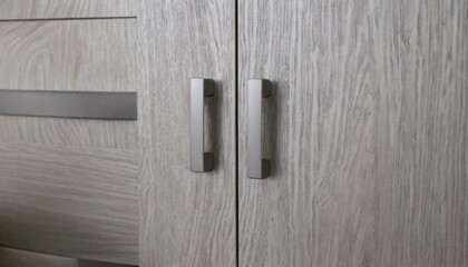 Close-Up of Stylish Light Gray Cabinet Handles in Modern Scandinavian Kitchen Interior