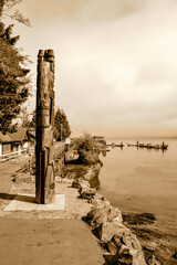 Indigenous Totem Pole Overlooking Serene Coastal Village