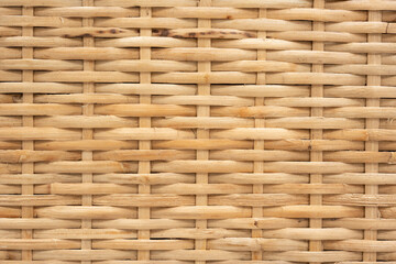Brown rattan intervoven into a repeated pattern. Used in furnitures, household tools such as baskets, etc. This image can be used as a background for artwork designs.
