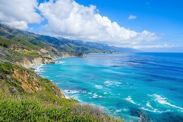 Obraz premium Scenic coastal view of a vibrant blue ocean meeting rugged cliffs under a bright sky with clouds