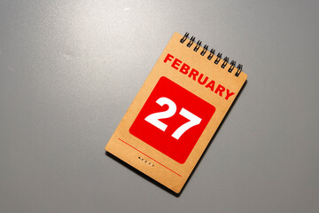 27 February on wooden grey cubes. Calendar cube date 27 February.