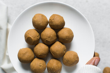 Top view of donkwa on a white plate, Overhead view of nigerian spicy donkwa, flatlay of tanfiri or groundnut cake on a white ceramic plate