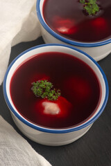 Traditional polish clear red borscht with dumplings with mushrooms