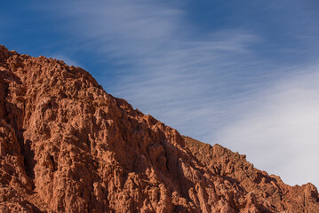 Rocky desert formations colorful red mountain with a blue sky 