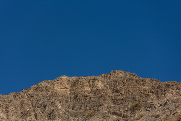 view of Rocky desert formations colorful arid mountain with a blue sky