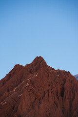 Rocky desert formations colorful red mountain with a blue sky 