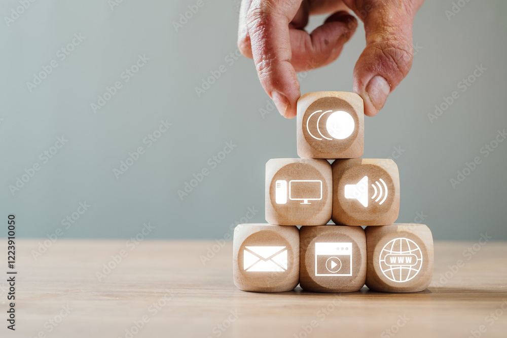 Poster wooden blocks with digital icons symbolize multimedia communication and technology in a modern setti