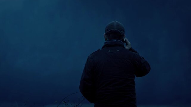 Man Talks On Phone In The Dark
