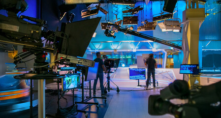 abstract blurred background with tv studio with lights and camera silhouettes