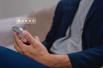 customer service evaluation and feedback rating. costumer review concept, man using phone chooses happy smiling face