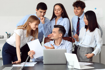 Group of business consultants working with laptop at table in office