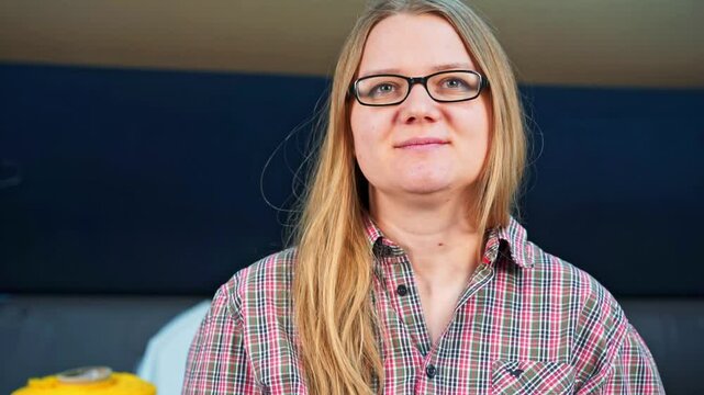 Woman in plaid shirt, glasses, with long hair, palaz top hand gesture, false approval, false support, hypocrisy Seller consultant recommends humor Insincere emotions, maternal feelings Plastic smile