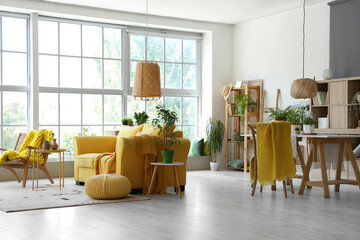 Interior of modern living room with yellow sofa and houseplants