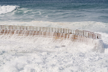 king tide waves crashing on the beach