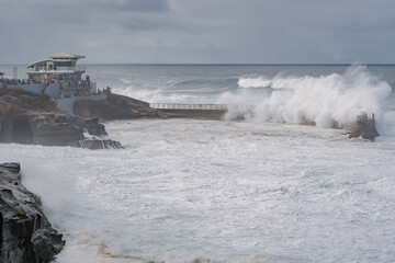 king tide waves crashing on the beach