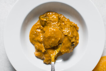 Overhead view of Nigerian owo soup in a spoon, top view of oghwo soup, traditional nigerian owo soup