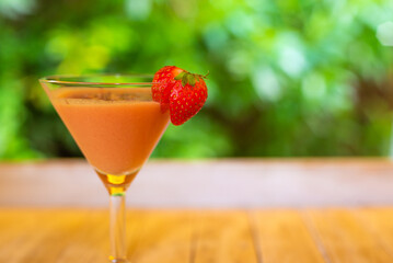 Vibrant cocktail with fresh strawberries at a celebration or event.