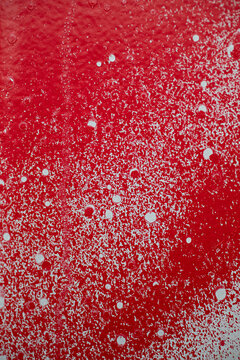 Close up of spray painted surface in red and white