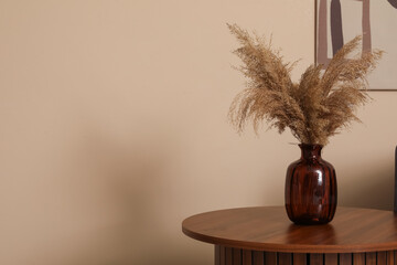 Pampas grass in vase on coffee table. Closeup