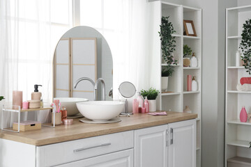 Sink with bath accessories on counters in room