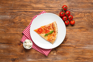 Plate with piece of tasty pizza Margarita and ingredients on wooden background