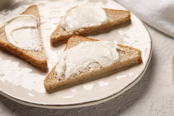 Plate of tasty bruschetta with processed cheese on grey background. Closeup