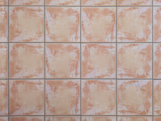 Fototapeta premium Top view of rustic earth clay porcelain ceramic tiles for interior or exterior floor, wall, porch. Textured reddish square slabs texture background. Mediterranean style decor.