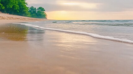 Obraz premium Serene Beach Sunset with Gentle Waves and Tranquil Shoreline Landscape in Soft Light