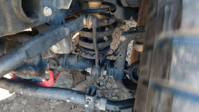 Watching the suspension system of a Jeep while driving over rough terrain.