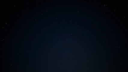 Fototapeta premium A dark sky without a moon, revealing a breathtaking view of the stars and the Milky Way in the distance.