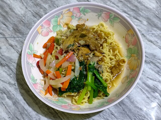 Mie, Mie ayam, mi ayam, or bakmi ayam is a common Indonesian dish consisting of seasoned yellow wheat noodles topped with chicken pieces. This dish originates from Chinese culinary techniques.
