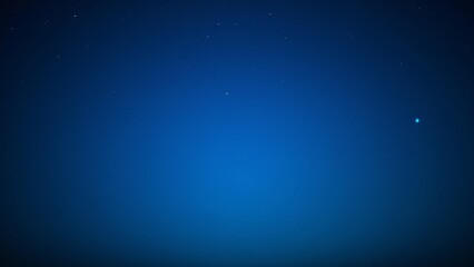 Fototapeta premium A peaceful night sky with a subtle blue glow caused by atmospheric light scattering, highlighting the stars.