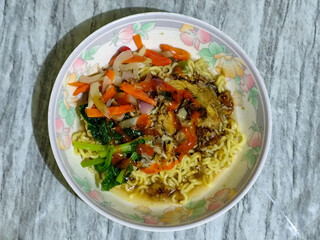 Mie, Mie ayam, mi ayam, or bakmi ayam is a common Indonesian dish consisting of seasoned yellow wheat noodles topped with chicken pieces. This dish originates from Chinese culinary techniques.