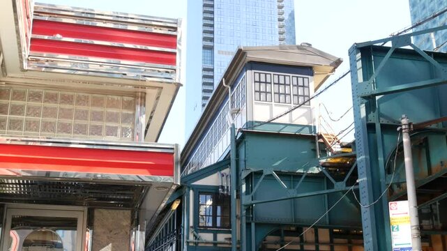 New York elevated subway, metropolitan bridge, metro track above street. Railway transport over road. Railroad line. Old cafe, diner restaurant. Court Square, Long Island city, Queens, United States
