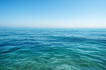 Obraz premium Tranquil seascape with clear turquoise waters under a bright blue sky, evoking calmness and serenity