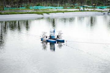 Photo of a waterwheel or aerator in a shrimp pond. A shrimp pond aerator or known as a water wheel is a tool that functions to increase oxygen levels in shrimp pond water.