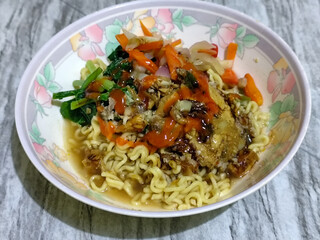 Mie, Mie ayam, mi ayam, or bakmi ayam is a common Indonesian dish consisting of seasoned yellow wheat noodles topped with chicken pieces. This dish originates from Chinese culinary techniques.