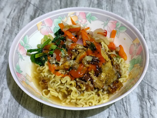 Mie, Mie ayam, mi ayam, or bakmi ayam is a common Indonesian dish consisting of seasoned yellow wheat noodles topped with chicken pieces. This dish originates from Chinese culinary techniques.