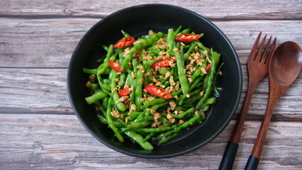 Stir fired raphanus caudatus beans with garlic and chili. (northern vegetable in Thailand)