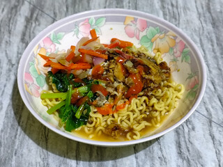 Mie, Mie ayam, mi ayam, or bakmi ayam is a common Indonesian dish consisting of seasoned yellow wheat noodles topped with chicken pieces. This dish originates from Chinese culinary techniques.