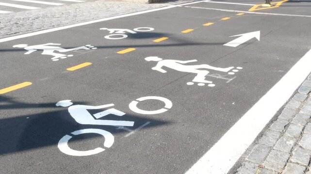 Bike lane asphalt sign, New York City. Bicycle path, cycle route for bicyclists, Manhattan. Way for roller skating and skates. Recreational sport activity infrastructure, biker cycling, United States.