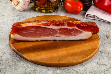 Piece prosciutto crudo over board