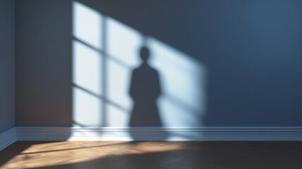 A person is standing in front of a window, casting a shadow on the wall