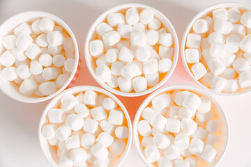 Minimalist white background with marshmallow boxes. Stylish sweet background. Top view