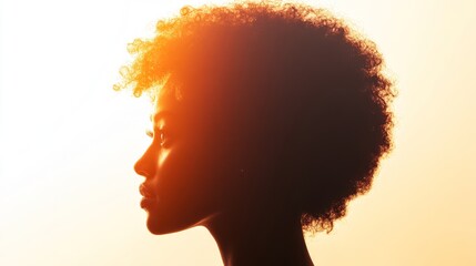 A woman with curly hair is shown in a silhouette